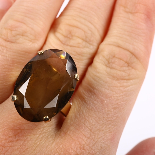 212 - A large late 20th century 9ct gold smoky quartz dress ring, set with oval mixed-cut quartz, length 2... 