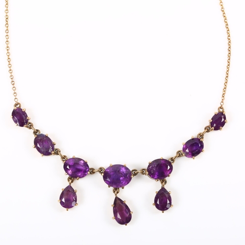 219 - A late 20th century 9ct gold amethyst fringe necklace, set with oval and pear-cut amethysts, on fine... 