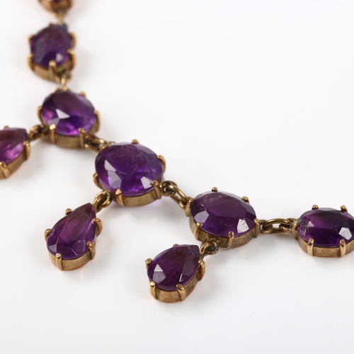 219 - A late 20th century 9ct gold amethyst fringe necklace, set with oval and pear-cut amethysts, on fine... 