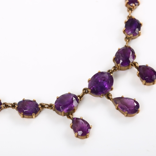 219 - A late 20th century 9ct gold amethyst fringe necklace, set with oval and pear-cut amethysts, on fine... 