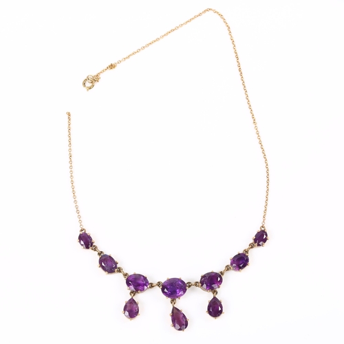 219 - A late 20th century 9ct gold amethyst fringe necklace, set with oval and pear-cut amethysts, on fine... 