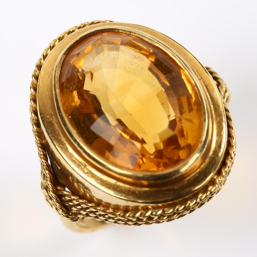 228 - A Continental 18ct gold citrine dress ring, with rope twist surround, setting height 22.4mm, size M,... 