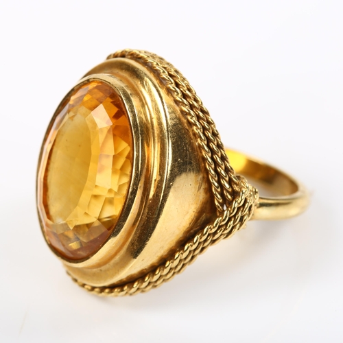 228 - A Continental 18ct gold citrine dress ring, with rope twist surround, setting height 22.4mm, size M,... 