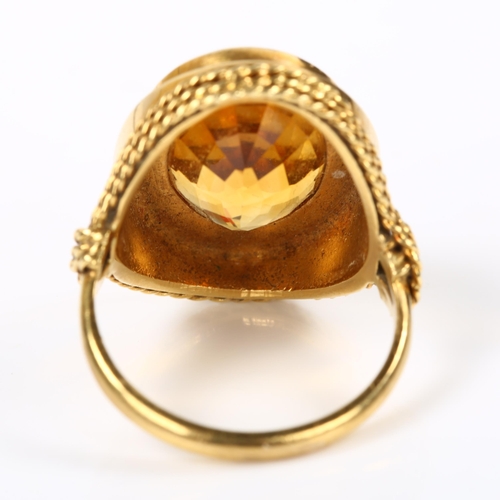 228 - A Continental 18ct gold citrine dress ring, with rope twist surround, setting height 22.4mm, size M,... 