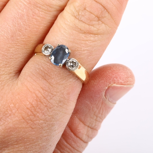 241 - An 18ct gold three stone sapphire and diamond ring, set with oval mixed-cut sapphire and modern roun... 