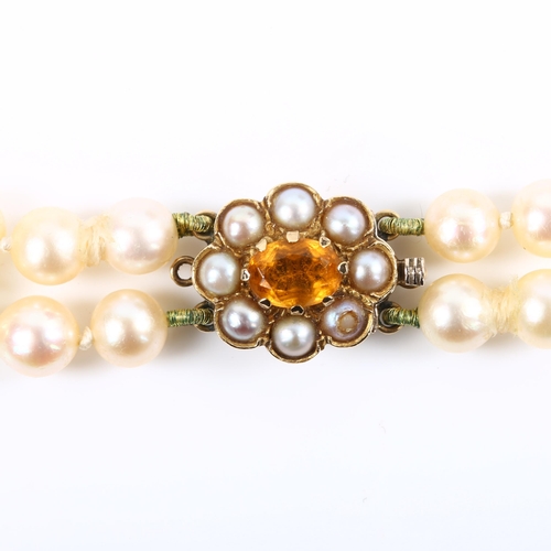 244 - A mid-20th century double-strand graduated pearl necklace, with 9ct citrine and split pearl clasp, h... 