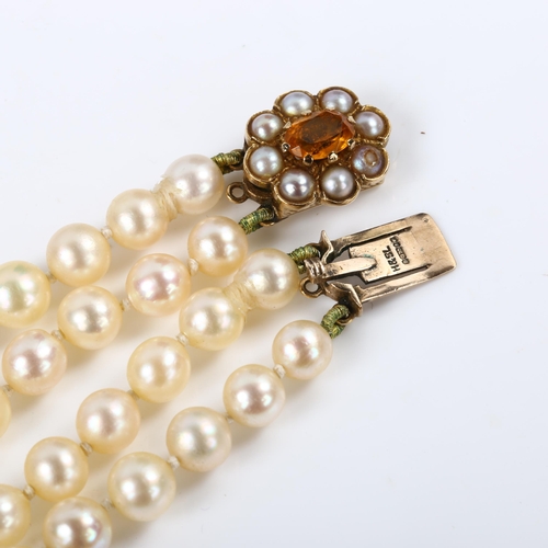 244 - A mid-20th century double-strand graduated pearl necklace, with 9ct citrine and split pearl clasp, h... 