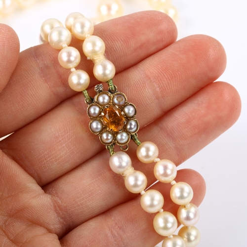 244 - A mid-20th century double-strand graduated pearl necklace, with 9ct citrine and split pearl clasp, h... 