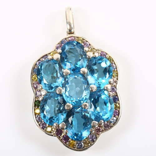 245 - A modern sterling silver blue topaz and vari-hue sapphire cluster pendant, set with oval mixed-cut t... 