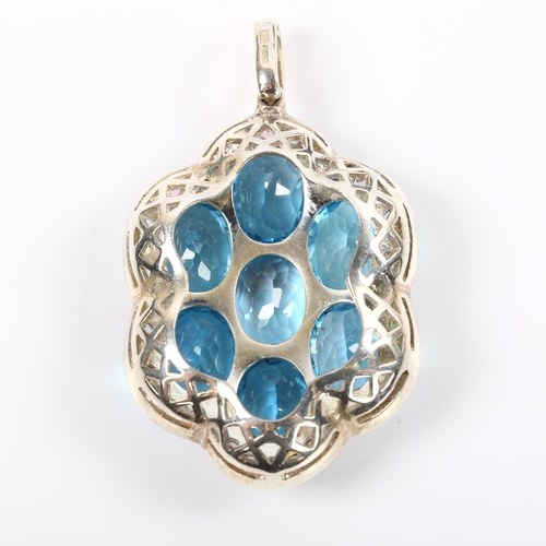 245 - A modern sterling silver blue topaz and vari-hue sapphire cluster pendant, set with oval mixed-cut t... 