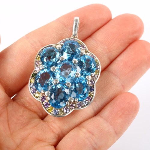 245 - A modern sterling silver blue topaz and vari-hue sapphire cluster pendant, set with oval mixed-cut t... 