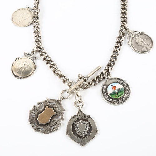 388 - FOOTBALL INTEREST - an early 20th century silver curb link Albert chain, with 6 silver fobs and meda... 