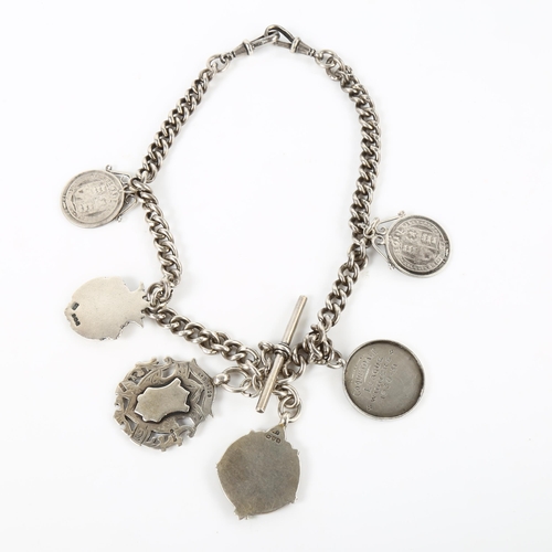 388 - FOOTBALL INTEREST - an early 20th century silver curb link Albert chain, with 6 silver fobs and meda... 