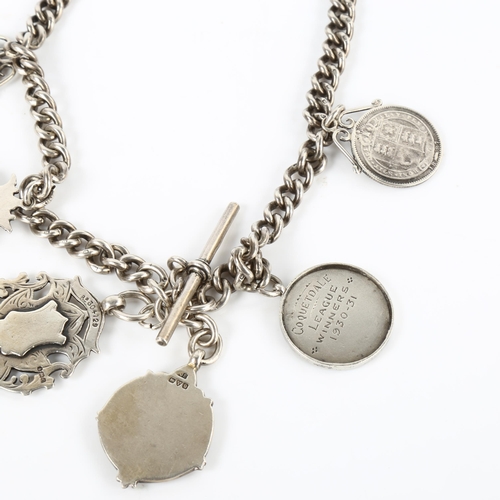 388 - FOOTBALL INTEREST - an early 20th century silver curb link Albert chain, with 6 silver fobs and meda... 