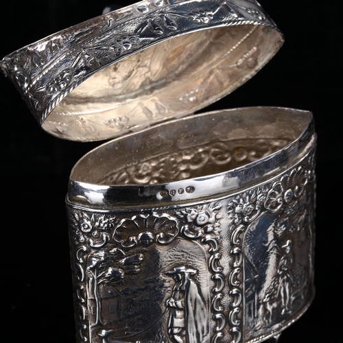 406 - A 19th century Dutch silver tea caddy, navette form with relief embossed figural and foliate decorat... 