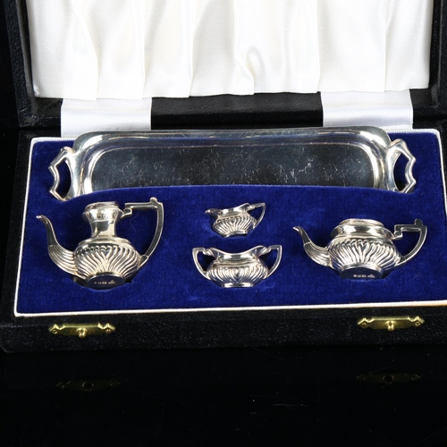 421 - An Elizabeth II miniature silver 5-piece doll's tea set, comprising 2-handled tray, hot water jug, t... 