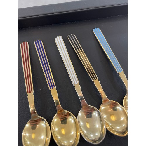 430 - ANTON MICHELSEN - a set of 12 Danish vermeil sterling silver and harlequin enamel coffee spoons, len... 