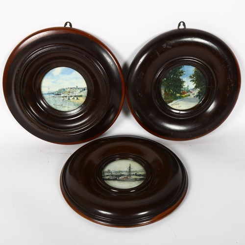 12 - A set of 3 turned lignum vitae circular picture frames, overall diameter 26cm (3)