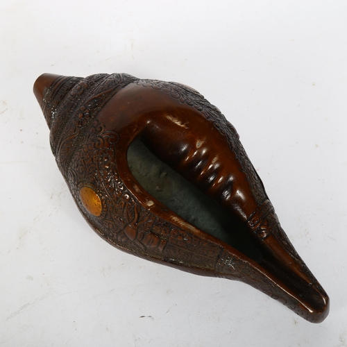 73 - A Chinese patinated bronze deity conch shell, length 23cm