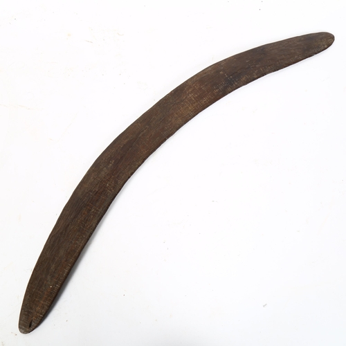 75 - An Australian Aboriginal carved wood boomerang, length 60cm