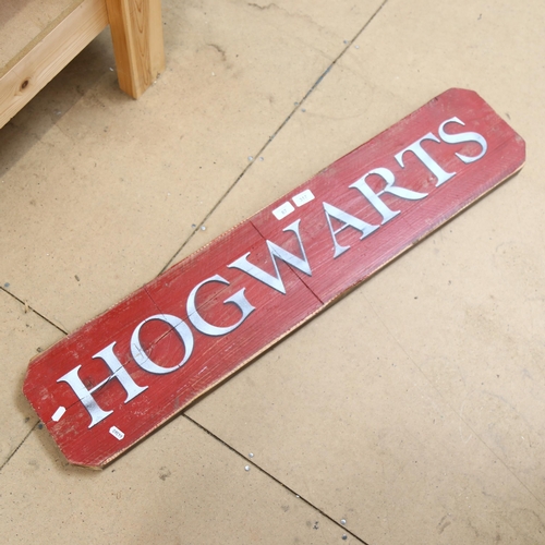 87 - A large painted pine Harry Potter Hogwarts sign, 22cm x 105cm