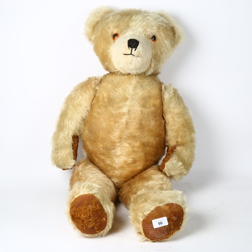 90 - A large Vintage straw-filled teddy bear, height 80cm