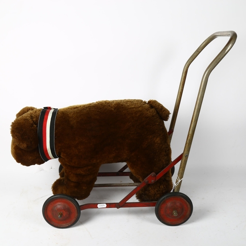 91 - A child's Vintage push-along bear toy, possibly Steiff, length 50cm