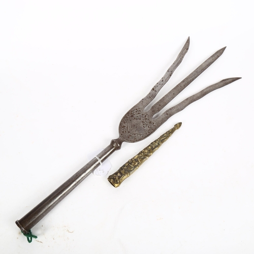 161 - A 19th century Middle Eastern steel Trident head, length 50cm, and a relief cast-brass dagger scabba... 