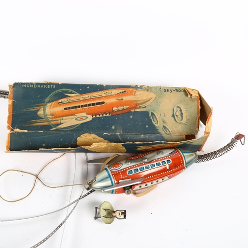 174 - A Vintage German Mondrakete tinplate clockwork sky/rocket toy, with parachuting figure, boxed, marke... 