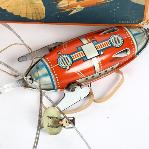 174 - A Vintage German Mondrakete tinplate clockwork sky/rocket toy, with parachuting figure, boxed, marke... 
