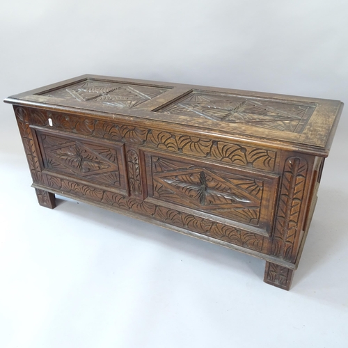 2059 - A 1930s oak blanket box, with carved and panelled decoration, 107cm x 45cm x 43cm