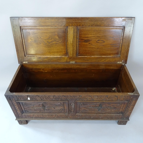 2059 - A 1930s oak blanket box, with carved and panelled decoration, 107cm x 45cm x 43cm