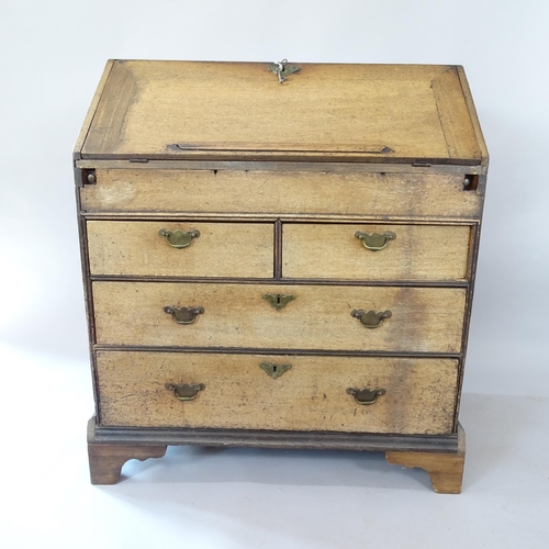 2060 - A 19th century oak bureau with well-fitted interior, 2 short and 2 long drawers below, on bracket fe... 