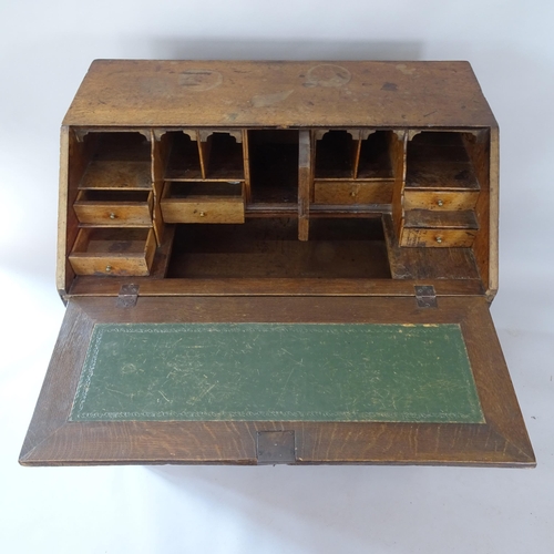 2060 - A 19th century oak bureau with well-fitted interior, 2 short and 2 long drawers below, on bracket fe... 