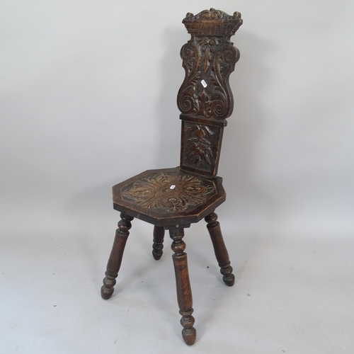 2068 - An Italian design oak hall chair, with carved back and seat