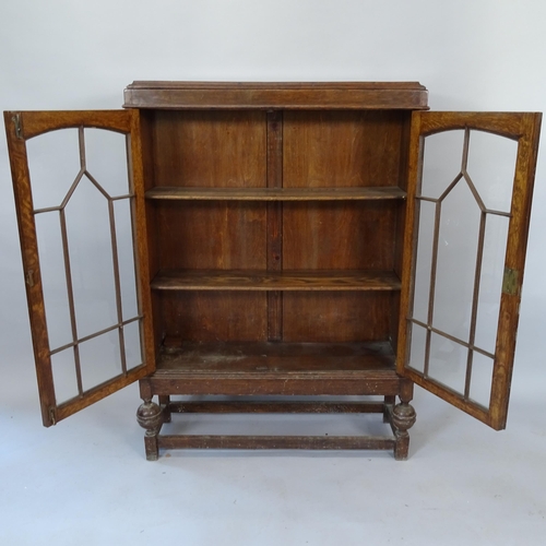 2069 - A Victorian oak bookcase, with 2 lattice-glazed doors and 2 adjustable shelves, 85cm x 118cm x 25cm ... 