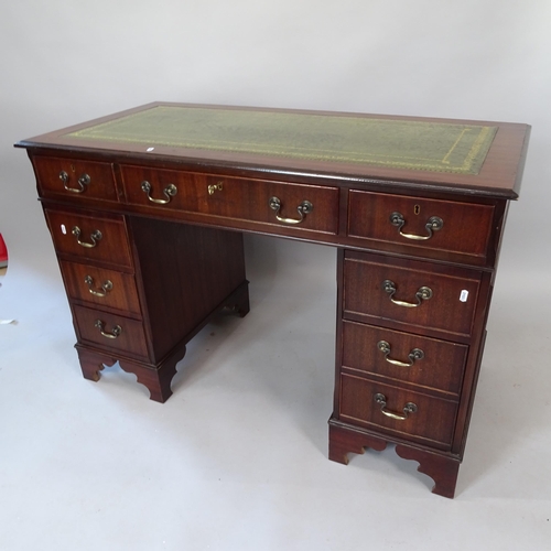 2070 - A reproduction mahogany pedestal writing desk, with tooled and embossed green leather skiver, and 9 ... 