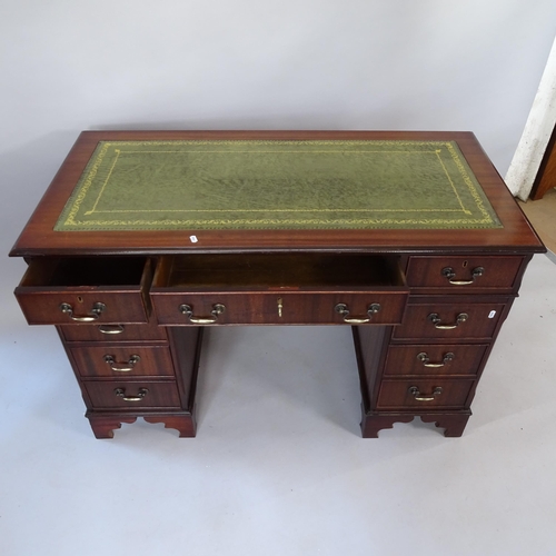 2070 - A reproduction mahogany pedestal writing desk, with tooled and embossed green leather skiver, and 9 ... 