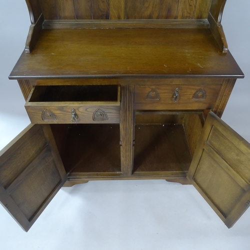 2075 - An oak 2-section dresser, with boarded open plate rack and carved panelled doors, 95cm x 188cm x 49c... 