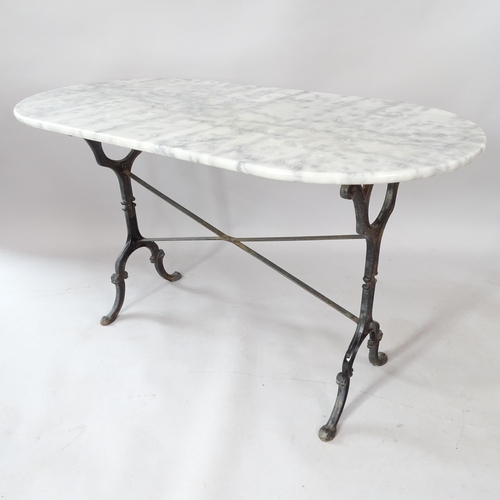 2077 - An oval marble-top garden table on cast-iron frame, 120cm x 73cm x 61cm