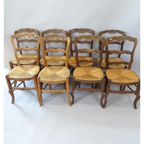 2100 - A set of 8 French oak rush-seated ladder-back dining chairs