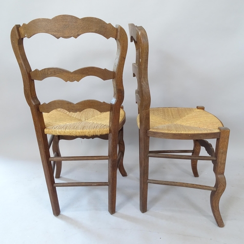 2100 - A set of 8 French oak rush-seated ladder-back dining chairs