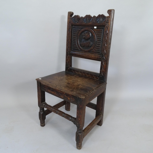 2110 - An 18th century oak hall chair with carved decoration