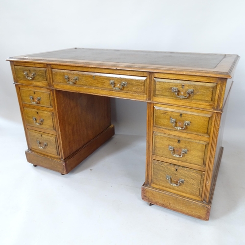 2114 - An early 20th century oak pedestal desk, with 9 fitted drawers and leather skiver, 122cm x 75cm x 64... 