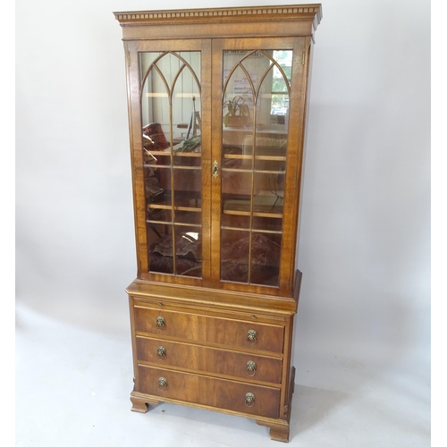 2116 - A reproduction mahogany single-section bookcase on chest, with 2 lattice-glazed doors, 3 adjustable ... 