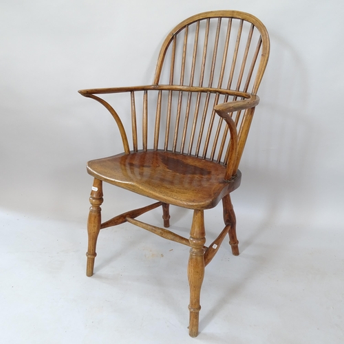 2120 - An Antique oak and elm-seated stick-back elbow chair