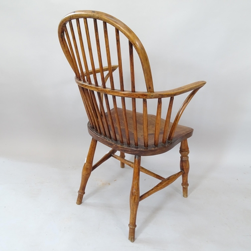 2120 - An Antique oak and elm-seated stick-back elbow chair