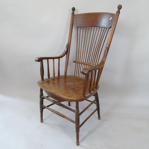 2124 - An Antique oak and elm-seated stick-back armchair