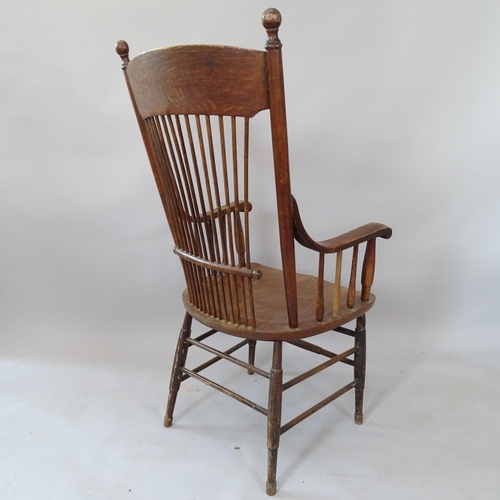 2124 - An Antique oak and elm-seated stick-back armchair