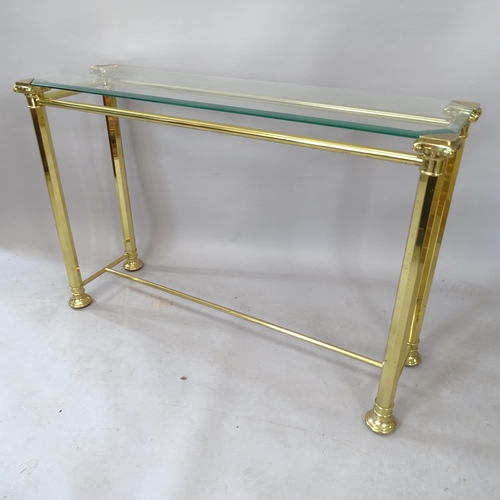 2125 - A brass Hollywood Regency style glass-top console table, L114cm, H76cm, D33cm, a nest of 3 brass Hol... 